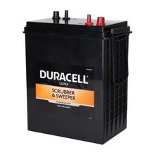 Angled perspective view of a black Duracell Ultra 6V scrubber battery showing terminal placement and carrying handle.